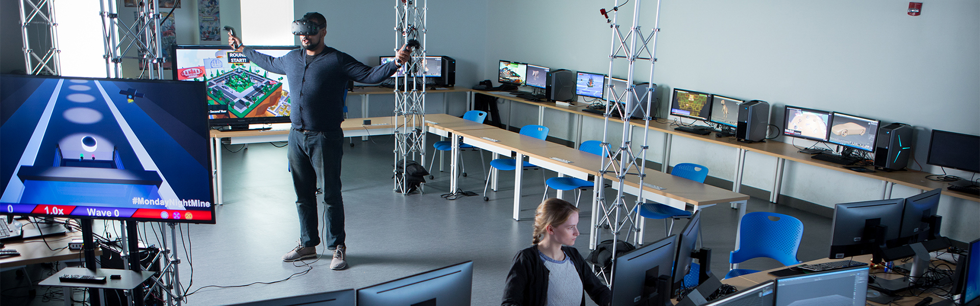 Students using virtual equipment in a game development lab